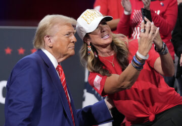 Republican presidential nominee former President Donald Trump poses for a photo with a supporter at a campaign event at the Cobb Energy Performing Arts Centre, Tuesday, Oct. 15, 2024, in Atlanta. (AP Photo/Alex Brandon)