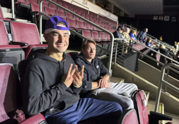 Robert Cabaniss, 28, left, and Taylor Lyze, 25, of Pittsburgh, await the start of a Democratic presidential candidate Vice President Kamala Harris rally at Erie Insurance Arena in Erie, Pa., Monday, Oct. 14, 2024. (AP Photo/Carolyn Thompson)