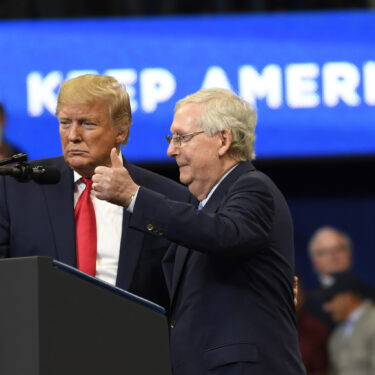 FILE - President Donald Trump brings Senate Majority Leader Mitch McConnell of Ky., on stage during a campaign rally in Lexington, Ky., Nov. 4, 2019. (AP Photo/Susan Walsh, File)