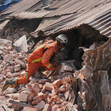 A rescuer works through rubble of a collapsed building following Friday's earthquake in Naypyitaw, Myanmar, Tuesday, April 1, 2025. (AP Photo)