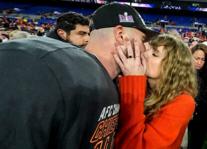 Taylor Swift kisses Kansas City Chiefs tight end Travis Kelce after an AFC Championship NFL football game against the Baltimore Ravens, Jan. 28, 2024, in Baltimore. The Kansas City Chiefs won 17-10. (AP Photo/Julio Cortez)