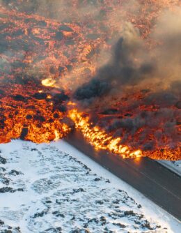 Lava crosses the main road to Grindavík and flows on the road leading to the Blue Lagoon in Grindavík, Iceland, Feb. 8, 2024. (AP Photo/Marco Di Marco)