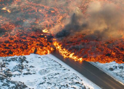 Lava crosses the main road to Grindavík and flows on the road leading to the Blue Lagoon in Grindavík, Iceland, Feb. 8, 2024. (AP Photo/Marco Di Marco)