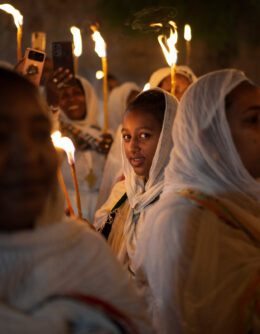 An Ethiopian Orthodox Christian pilgrim looks at the camera as she holds a candle during the procession of the Holy Fire at the Ethiopian monks’ village Deir Al-Sultan, located on the rooftop of the Church of the Holy Sepulchre where many Christians believe Jesus was crucified, buried and rose from the dead, in the Old City of Jerusalem, May 4, 2024. (AP Photo/Leo Correa)