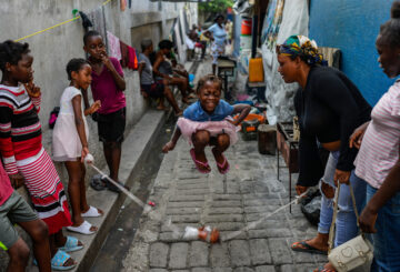 A girl plays a jump rope game at a school housing residents displaced by gang violence in Port-au-Prince, Haiti, May 15, 2024. (AP Photo/Ramon Espinosa)