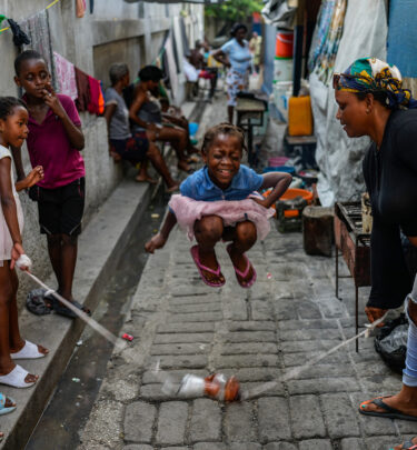 A girl plays a jump rope game at a school housing residents displaced by gang violence in Port-au-Prince, Haiti, May 15, 2024. (AP Photo/Ramon Espinosa)