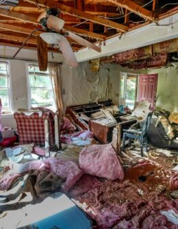 Cindy White looks over the devastation inside her home caused by Hurricane Helene, Oct. 1, 2024 in Morganton, N.C. The adjacent Catawba River flooded due to the torrential rains destroying the seven of family’s nine homes on the property. (AP Photo/Kathy Kmonicek)