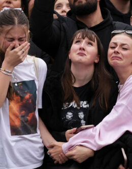 Fans react as they gather near the Peter Pan statue in Hyde Park, London, to pay tribute to late British singer Liam Payne, former member of the British pop band One Direction, Oct. 20, 2024. (AP Photo/Scott A. Garfitt/Invision)