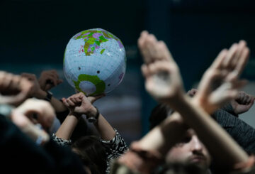 Activists hold an inflatable globe as they demonstrate in silence protesting a draft of a proposed deal for curbing climate change at the COP29 U.N. Climate Summit, Nov. 22, 2024, in Baku, Azerbaijan. (AP Photo/Rafiq Maqbool)