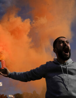 A man waves a flare during a celebratory demonstration following the first Friday prayers since Bashar Assad's ouster in Damascus’ central square, Syria, Dec. 13, 2024. (AP Photo/Leo Correa)