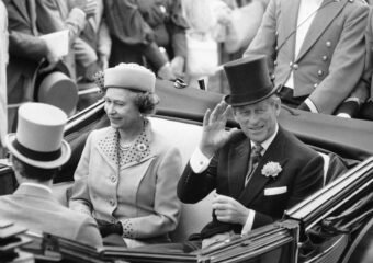 Queen Elizabeth II and the Duke of Edinburgh drive in an open carriage down the course at Ascot are track, June 18, 1985, for the start of the Royal Ascot race meeting, the first day of the four-day meeting. (AP Photo/Dave Caulkin)